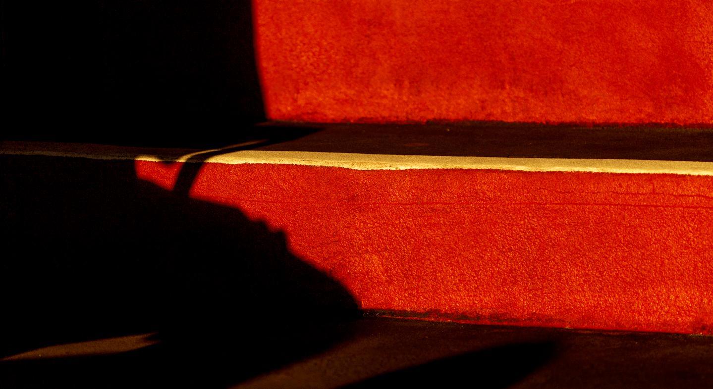 Red and gold steps with a shadow cast over them