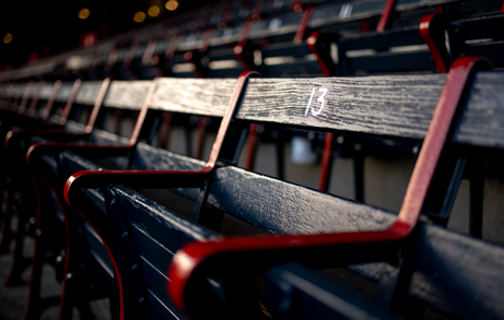 vintage black and red wooden seats in a baseball park